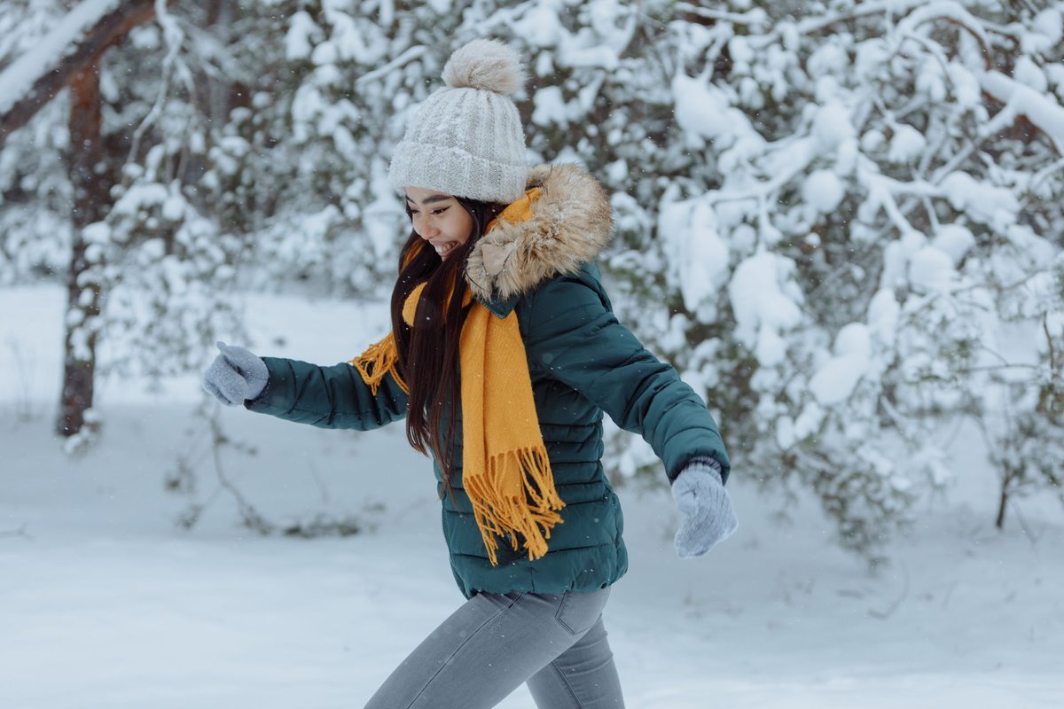 Corredor con ropa de invierno en un camino nevado: correr con frío al aire libre